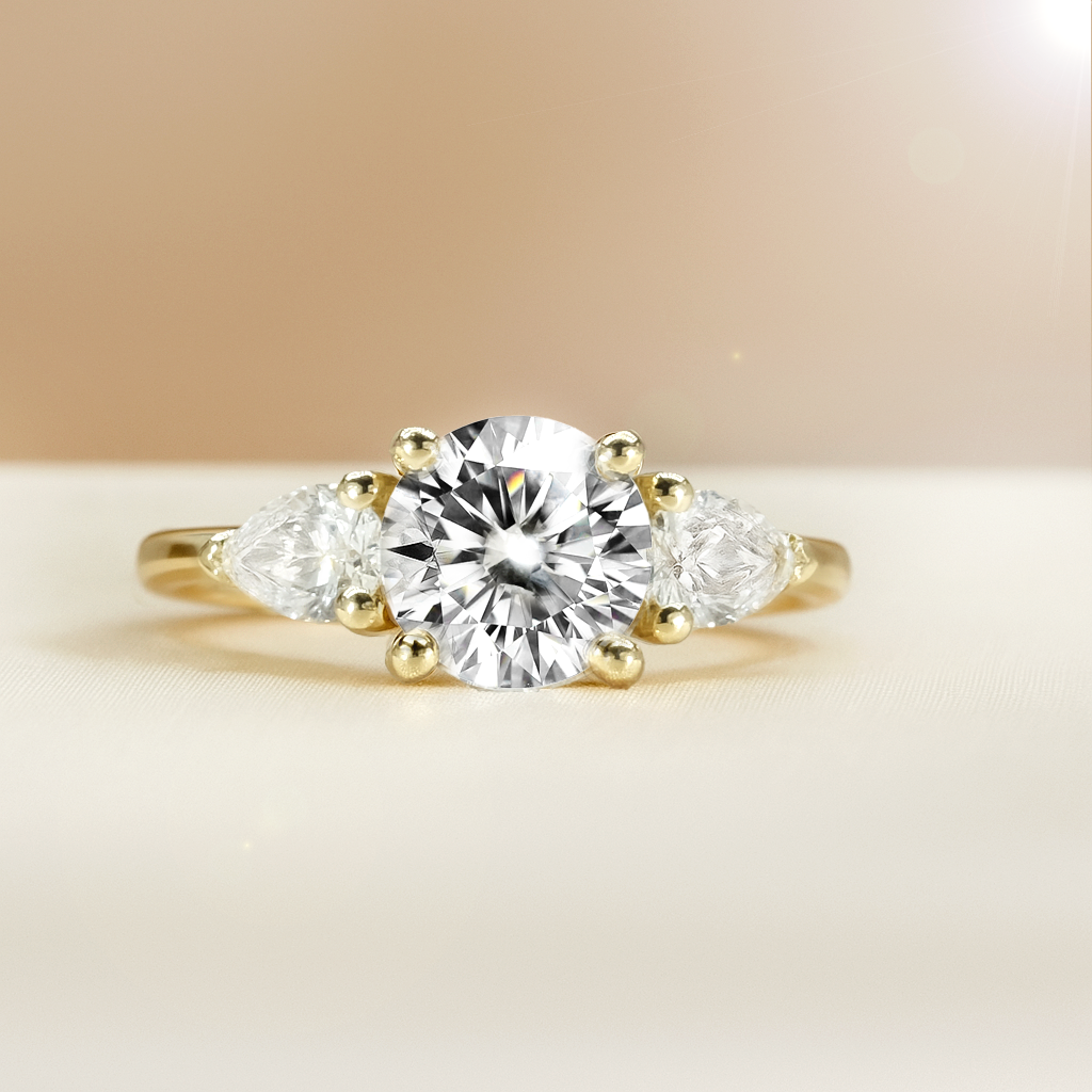 The Alexandra Ring - Round Trilogy with Pear Side Stones