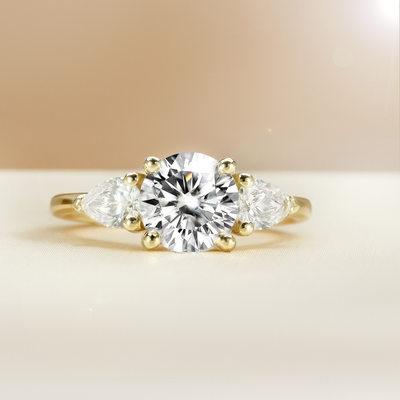 The Alexandra Ring - Round Trilogy with Pear Side Stones